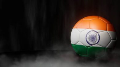 Soccer ball in flag colors on a dark abstract background.