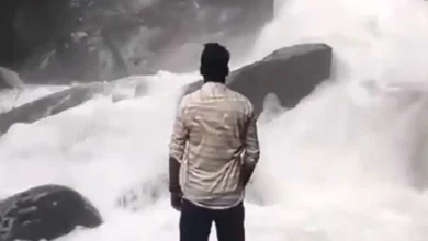 Man posing in a waterfall