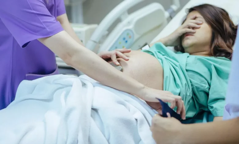 0 Examining the belly of a pregnant woman
