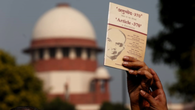 Waving a booklet on Article 370 outside the Supreme Court on Monday. Praveen Khanna